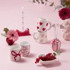 Bougie dans pot céramique blanc motif noeud rouge Ø8xH9cm (2 modèles)