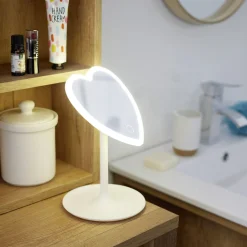 Miroir lumineux LED sur pied inclinable plastique blanc forme coeur 16xH24cm